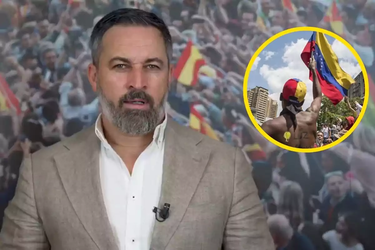 Hombre con barba y saco claro hablando frente a una multitud con banderas españolas, con un recuadro que muestra a una persona sosteniendo una bandera de Venezuela.