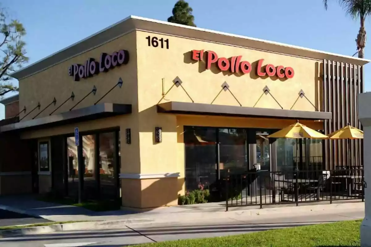 El Pollo Loco fast food restaurant with yellow walls, large windows, and yellow umbrellas on the outdoor terrace. El Pollo Loco fast food restaurant with yellow walls, large windows, and yellow umbrellas on the outdoor terrace.