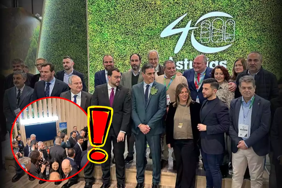 Un grupo de personas posando frente a un fondo verde con el logo de Asturias, con un círculo rojo y un signo de exclamación resaltando una parte de la imagen.