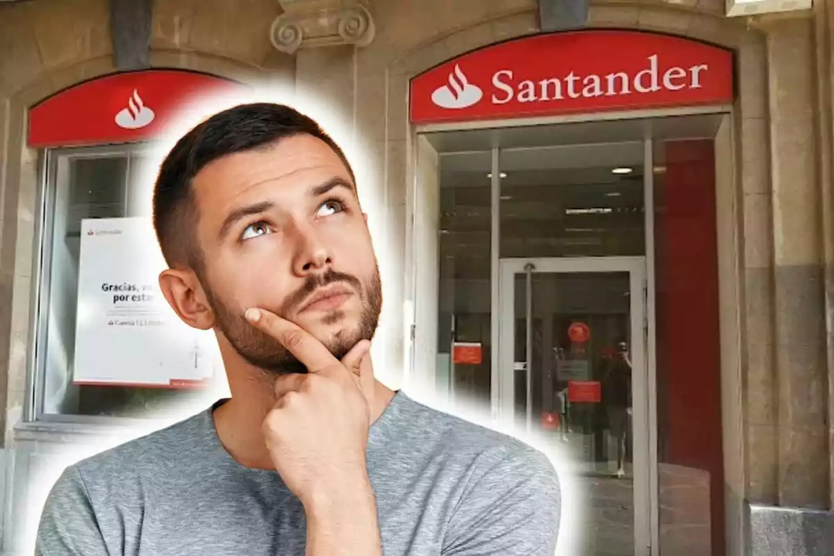 Un hombre pensativo frente a una sucursal del banco Santander.