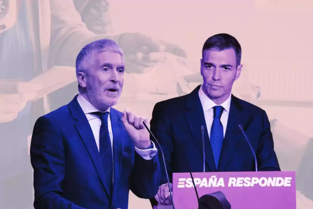 Dos hombres con traje en un evento político con un cartel que dice España responde y una imagen de fondo de una persona depositando un sobre