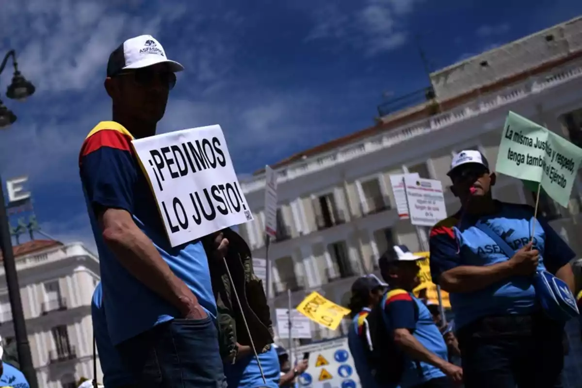 People participating in a demonstration with signs in a public square.