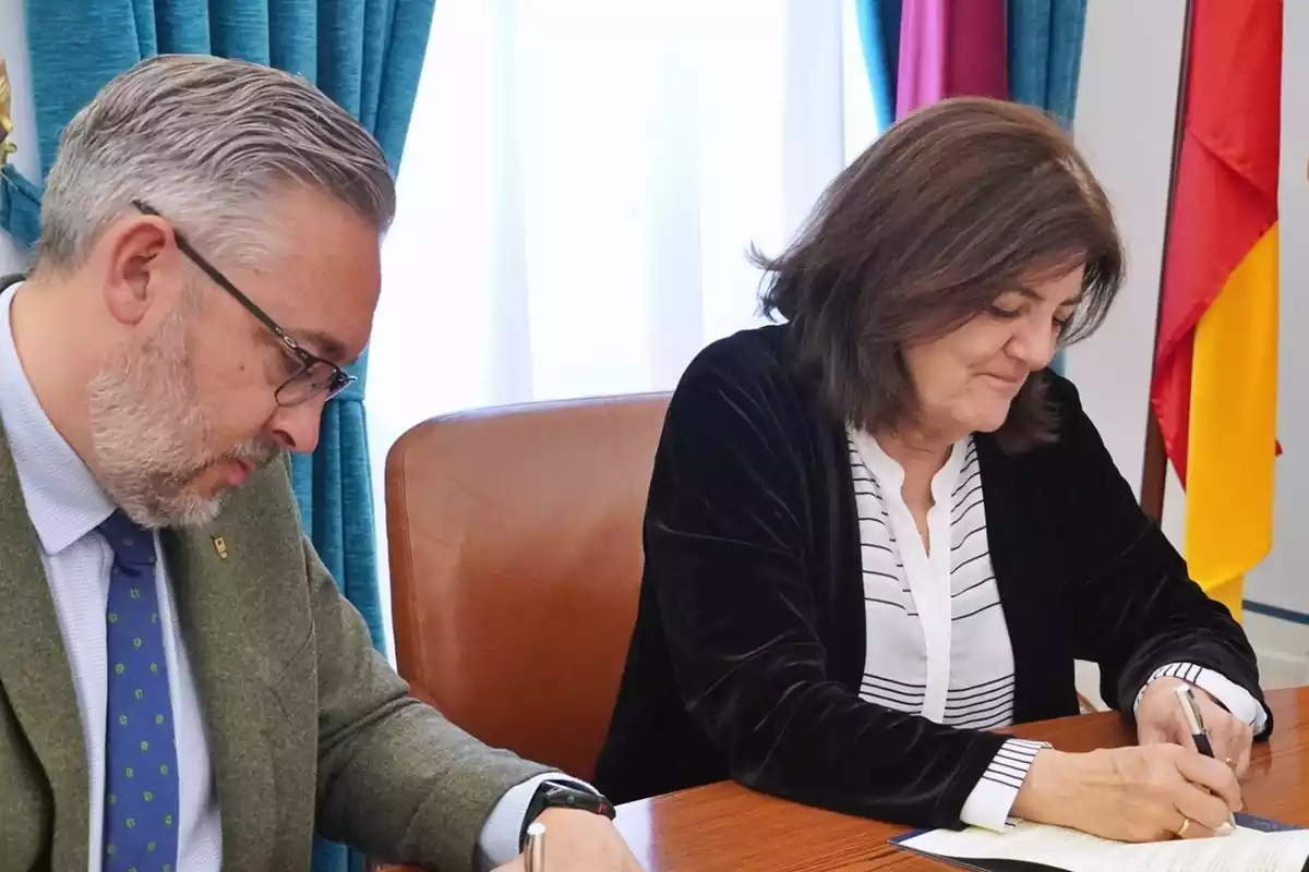 María Dolores García Mascarell firmando documentos en la UCAM