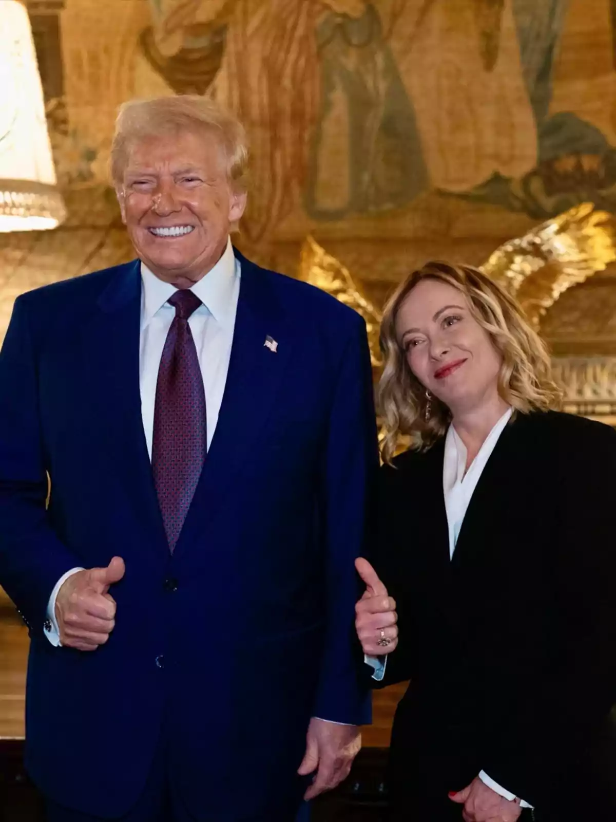 Two people posing together, both wearing formal suits and giving a thumbs up, in a stylish indoor setting. Two people posing together, both wearing formal suits and giving a thumbs up, in a stylish indoor setting.
