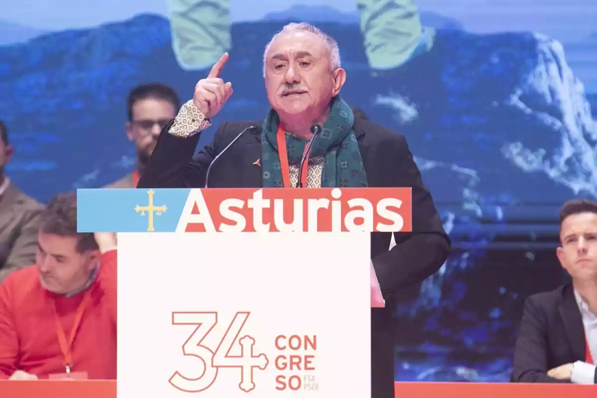 A man speaking at a podium during a conference in Asturias. A man speaking at a podium during a conference in Asturias.