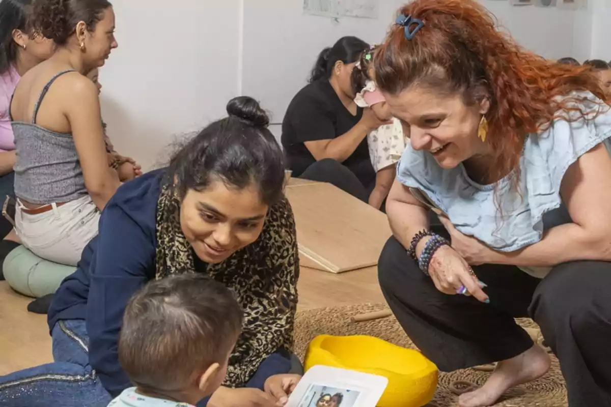 A group of people interacts with a small child in a welcoming environment.