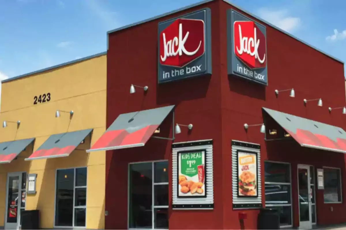 Fast food restaurant building with red and yellow signs and awnings.