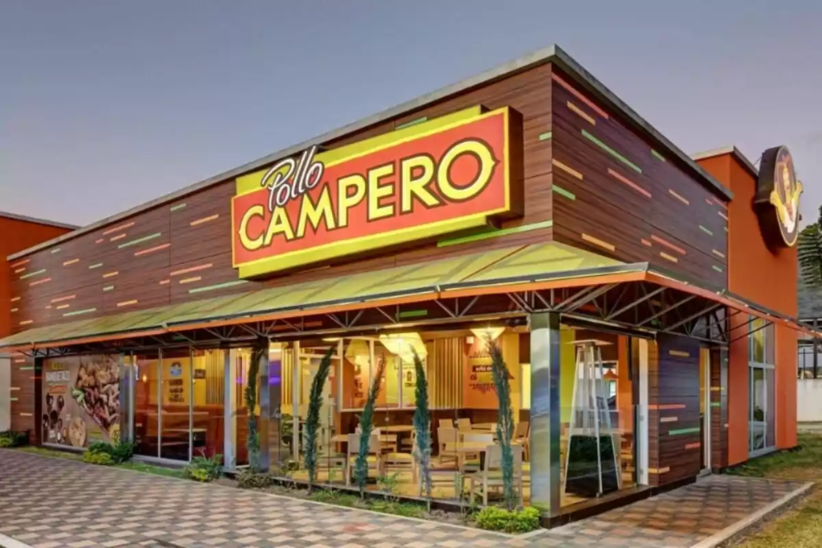 A fast-food restaurant with a large, colorful sign outside, surrounded by modern design and decorative plants. A fast-food restaurant with a large, colorful sign outside, surrounded by modern design and decorative plants.