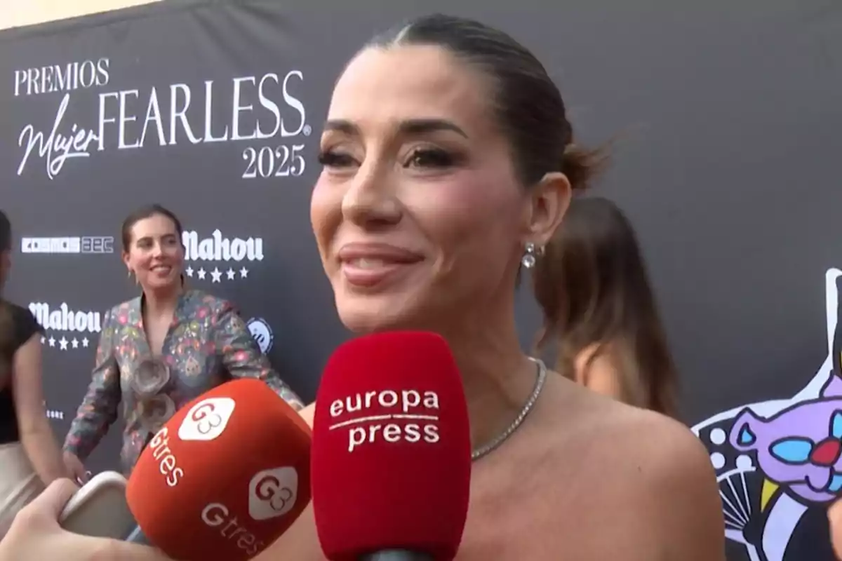 Elena Tablada sonriendo durante una entrevista en la alfombra roja de los Premios Mujer Fearless 2025 con micrófonos de prensa frente a ella y un fondo con logotipos de patrocinadores. Elena Tablada sonriendo durante una entrevista en la alfombra roja de los Premios Mujer Fearless 2025 con micrófonos de prensa frente a ella y un fondo con logotipos de patrocinadores.
