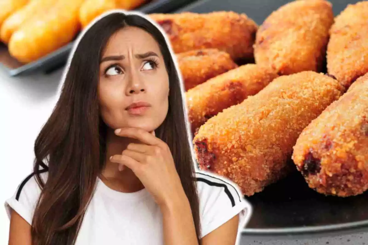 Una mujer pensativa con croquetas en el fondo.