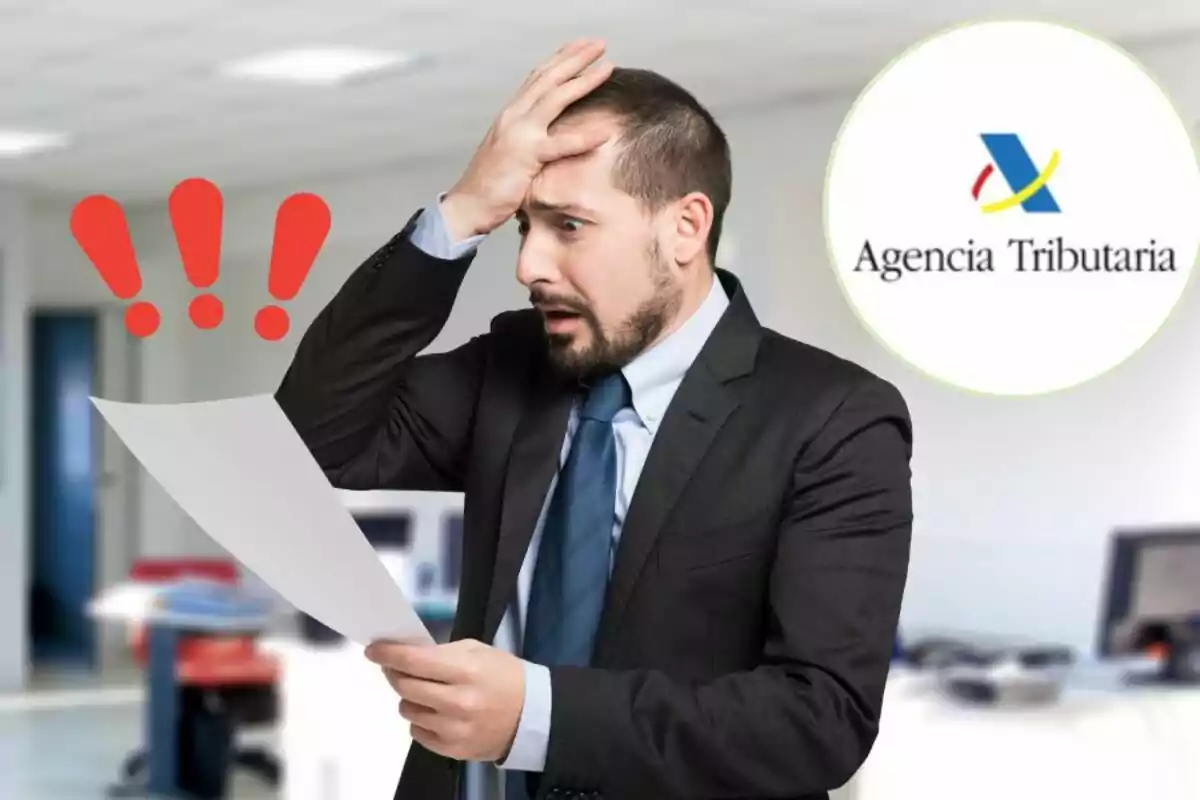 Man in suit with surprised or worried expression while holding a document in an office with an agency logo in the background.