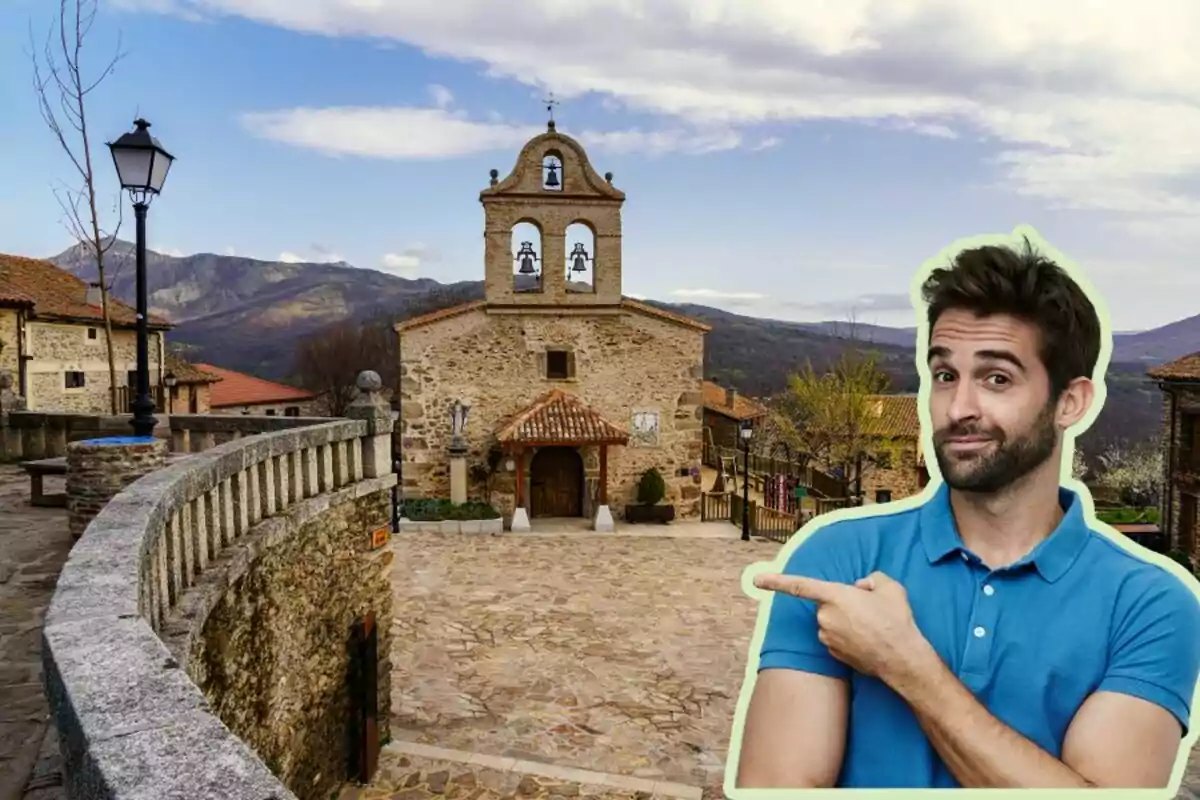 Un hombre con camisa azul señala hacia una iglesia de piedra en Hiruela