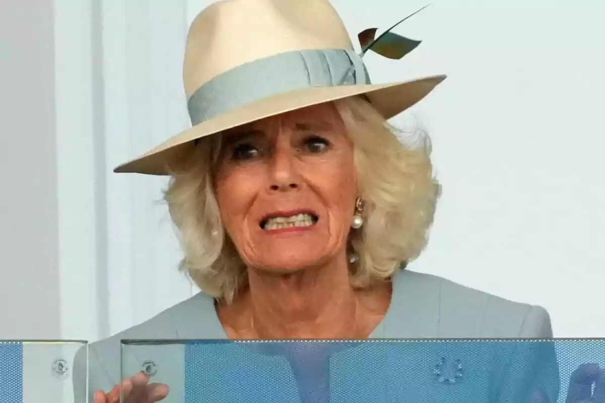 A person with a light hat and a facial expression of surprise or concern. A person with a light hat and a facial expression of surprise or concern.