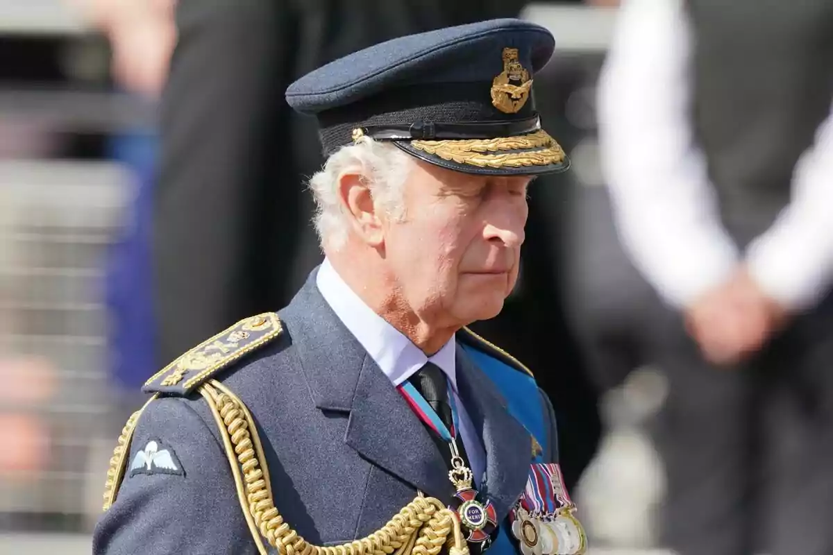 A man in a blue military uniform and a cap decorated with medals and golden cords. A man in a blue military uniform and a cap decorated with medals and golden cords.