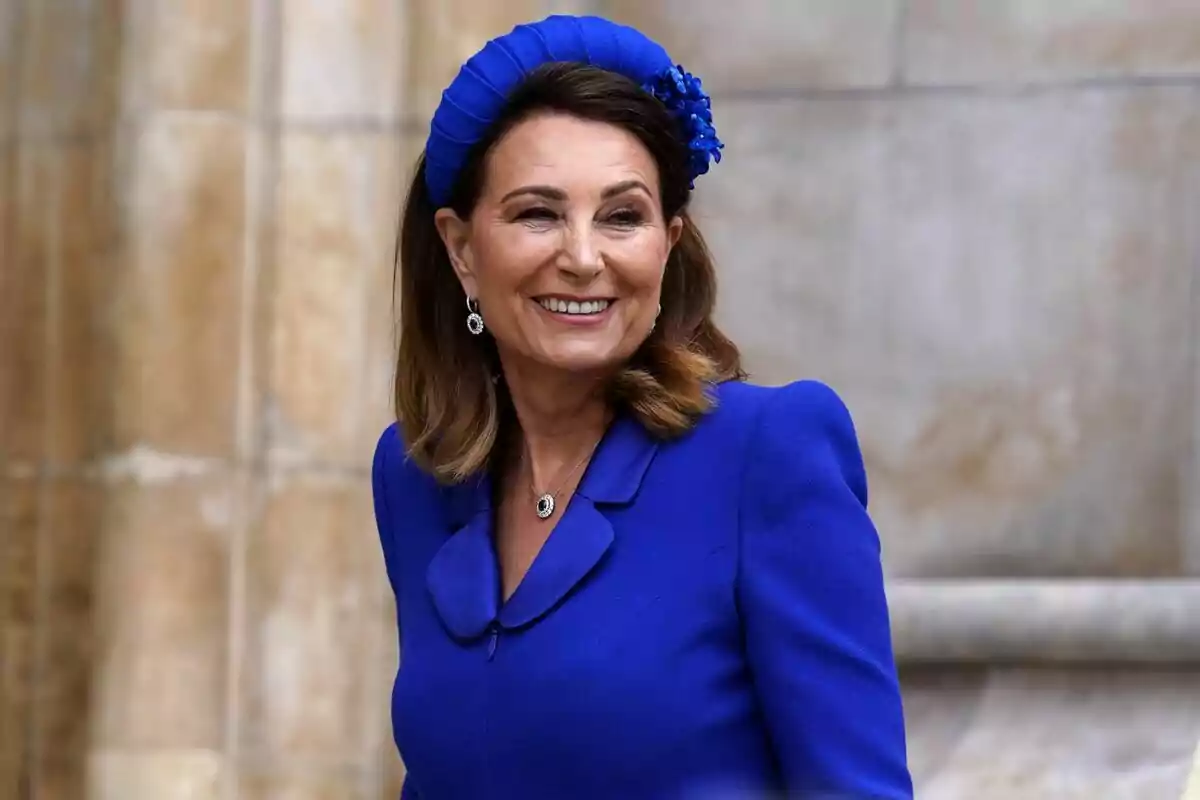 A smiling woman in a blue dress with a matching headpiece. A smiling woman in a blue dress with a matching headpiece.