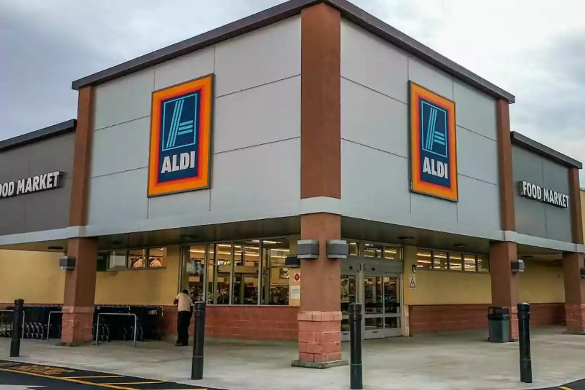Storefront of a supermarket with the Aldi logo on the corner of the building.