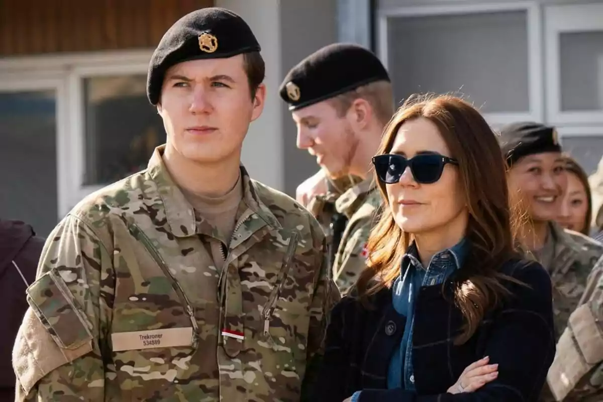A group of people dressed in military uniforms, one of them wearing sunglasses and standing next to a soldier. A group of people dressed in military uniforms, one of them wearing sunglasses and standing next to a soldier.