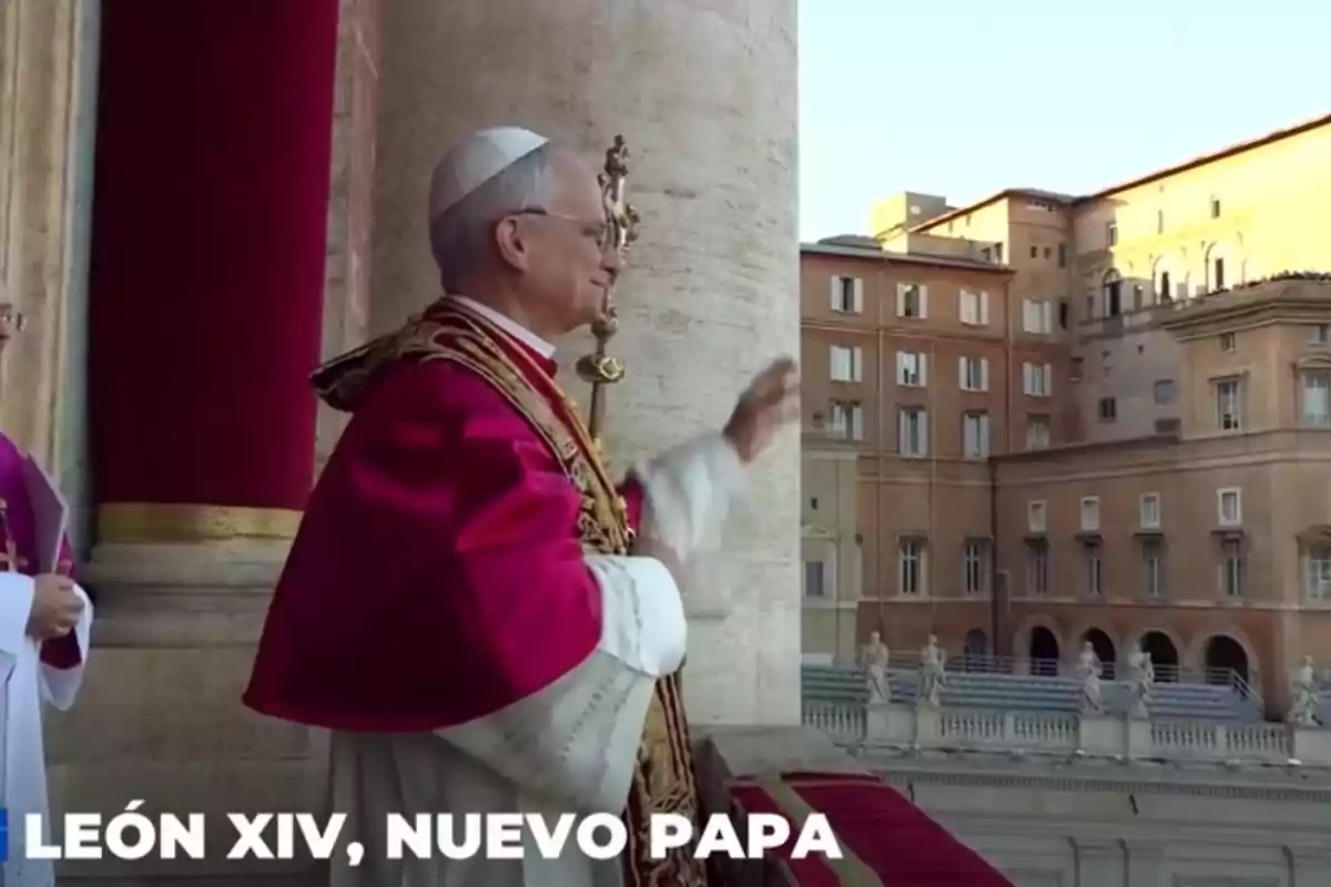 A man dressed in papal attire waves from a balcony with a historic building in the background. A man dressed in papal attire waves from a balcony with a historic building in the background.