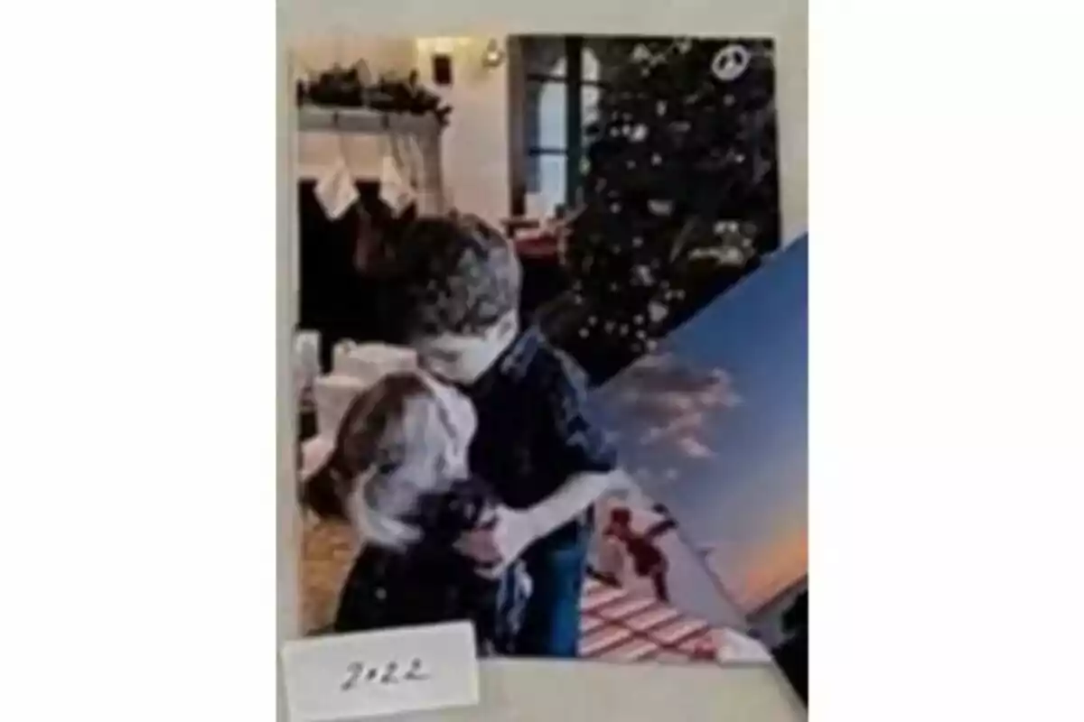 A boy hugs a dog in front of a decorated Christmas tree, with a fireplace and stockings hanging in the background. A boy hugs a dog in front of a decorated Christmas tree, with a fireplace and stockings hanging in the background.