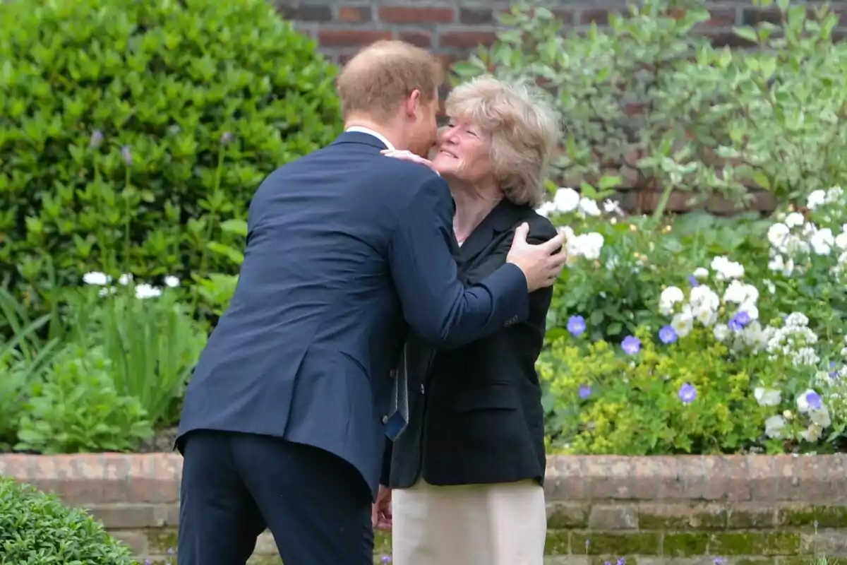 A man and a woman embrace in a garden full of flowers and greenery. A man and a woman embrace in a garden full of flowers and greenery.