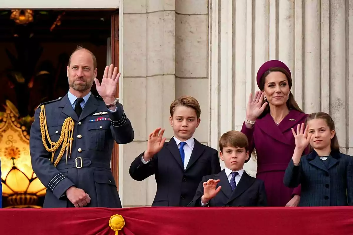 A group of formally dressed people waving from a balcony. A group of formally dressed people waving from a balcony.