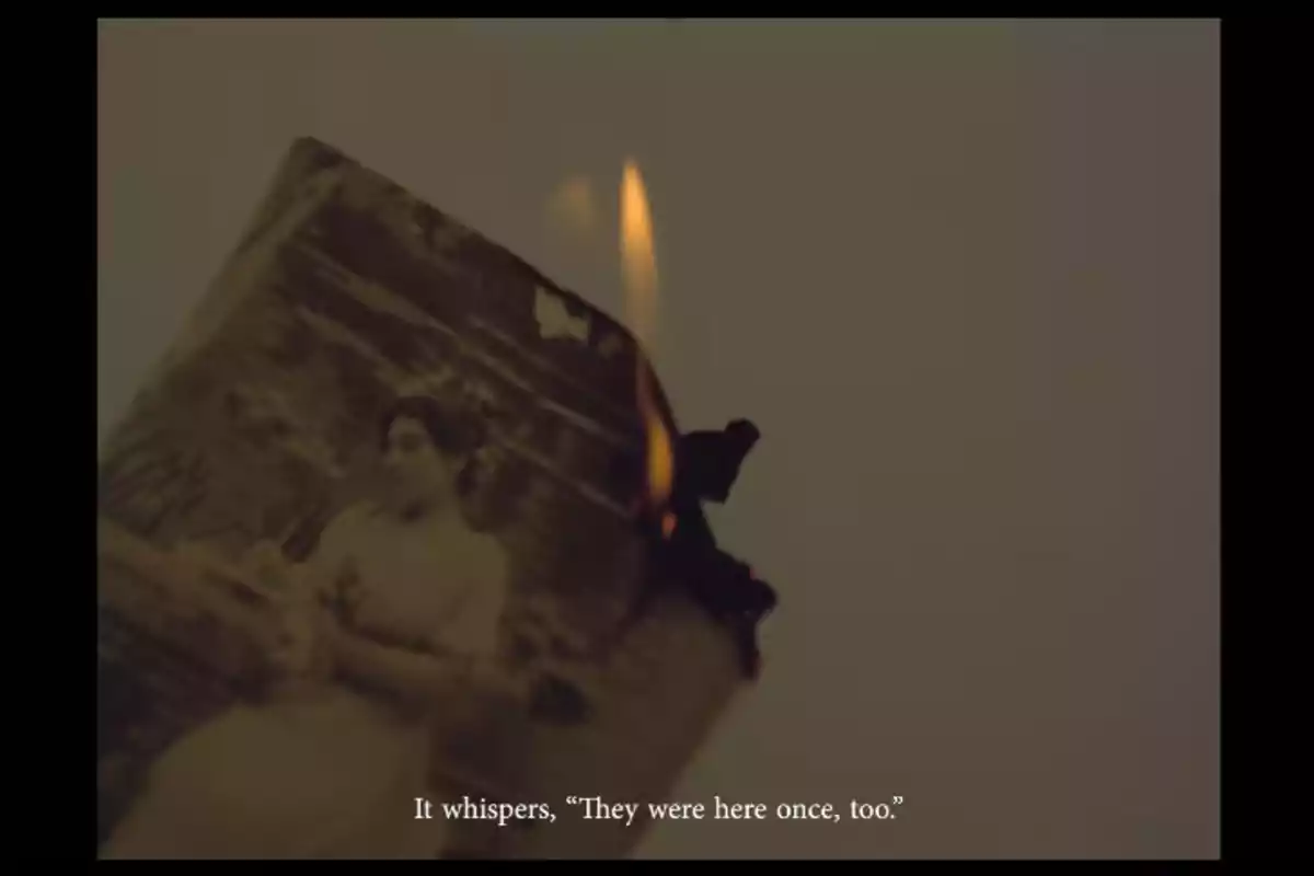 An old photograph of a person is being burned, with a visible flame at the edge, and the text at the bottom says: An old photograph of a person is being burned, with a visible flame at the edge, and the text at the bottom says: