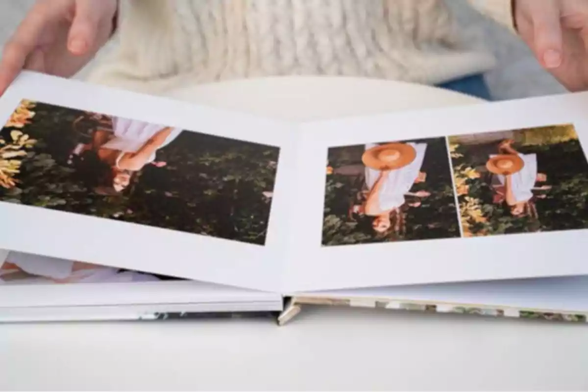 A person flips through a photo album with pictures of a woman in a garden.