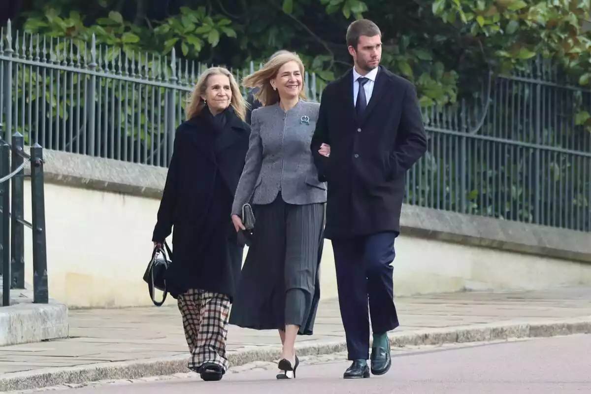 La infanta Elena con un abrigo gris y unos pantalones de cuadros, la infanta Cristina sonriendo con un traje gris y Juan Urdangarin serio con un traje negro La infanta Elena con un abrigo gris y unos pantalones de cuadros, la infanta Cristina sonriendo con un traje gris y Juan Urdangarin serio con un traje negro