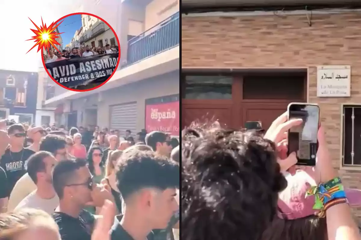 Una multitud de personas se ha reunido en una calle, algunas de ellas sosteniendo pancartas y otras tomando fotos con sus teléfonos móviles.