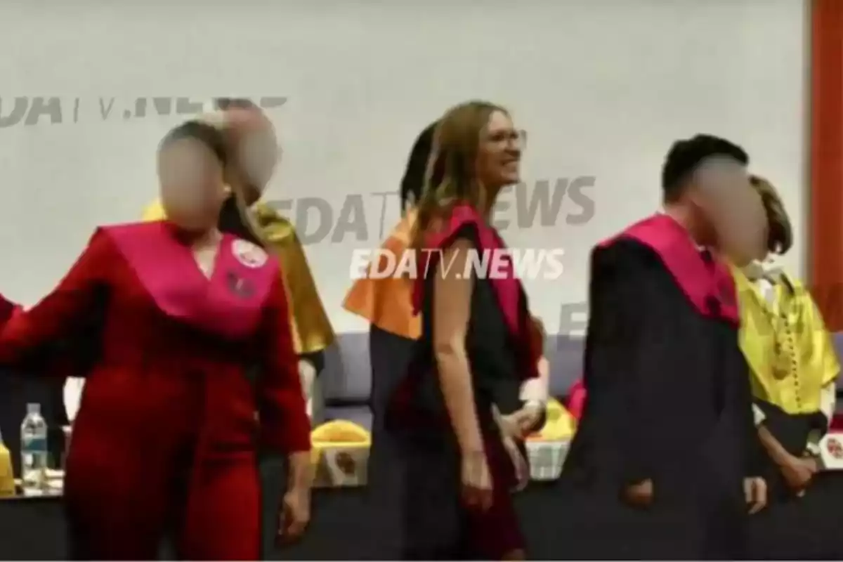 People at a graduation ceremony wearing academic attire with blurred faces.