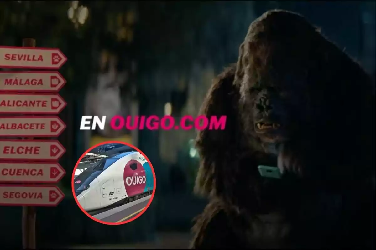 Un gorila sostiene un teléfono móvil junto a un cartel con direcciones de ciudades españolas y el texto "EN OUIGO.COM" en el centro, con una imagen de un tren OUIGO en la esquina inferior izquierda.