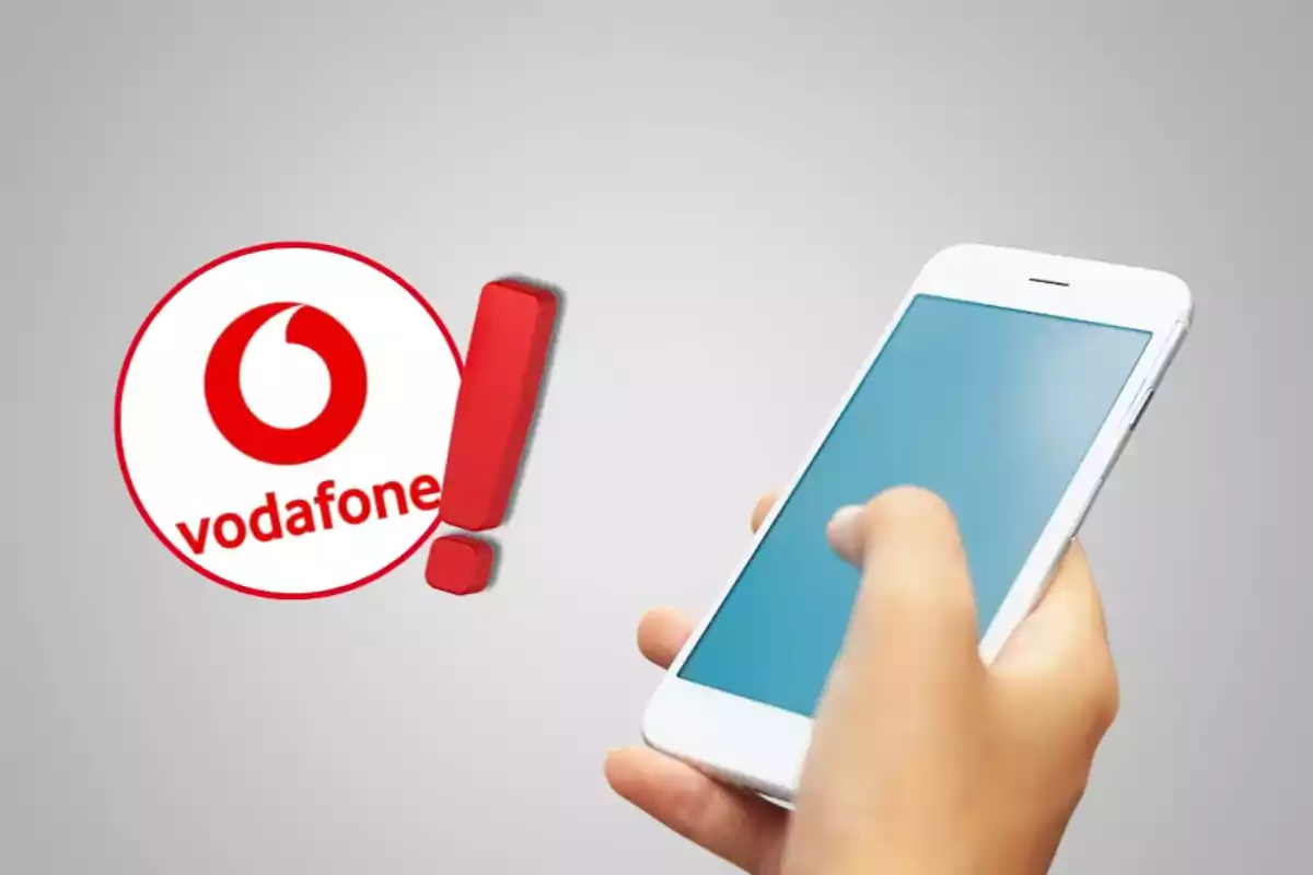 Una mano sosteniendo un teléfono inteligente con el logotipo de Vodafone y un signo de exclamación rojo al lado.