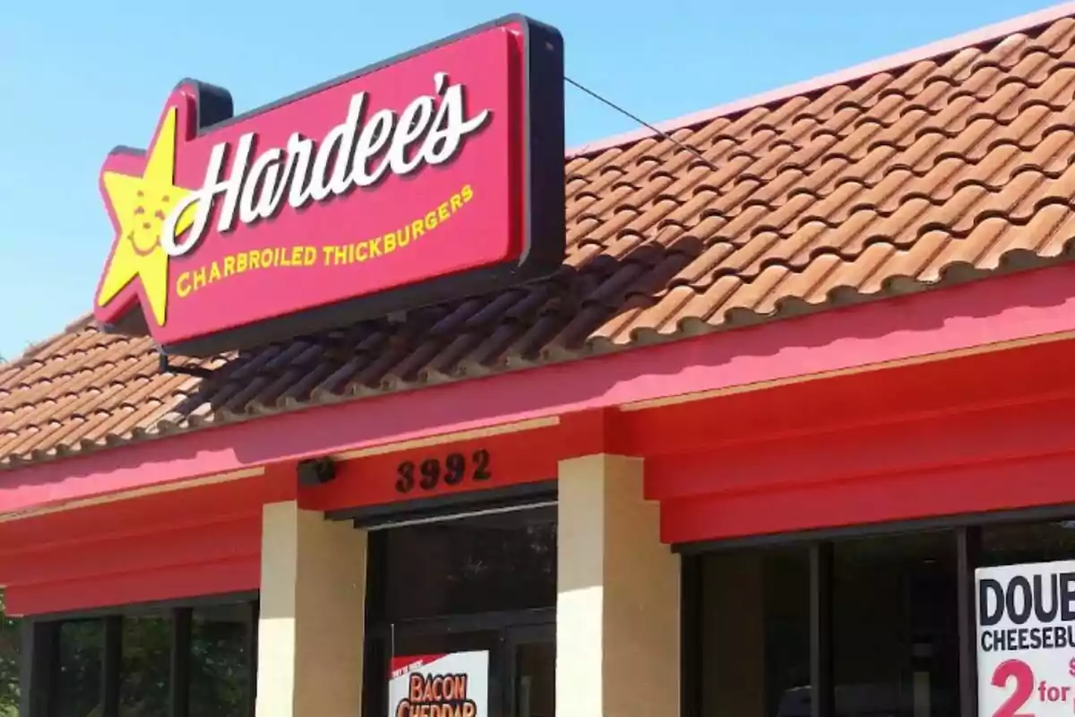 Facade of a Hardee's restaurant with a red and yellow sign and a tiled roof.