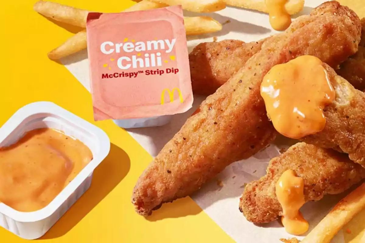 Breaded chicken sticks accompanied by French fries and a creamy chili sauce from McDonald's on a yellow background. Breaded chicken sticks accompanied by French fries and a creamy chili sauce from McDonald's on a yellow background.