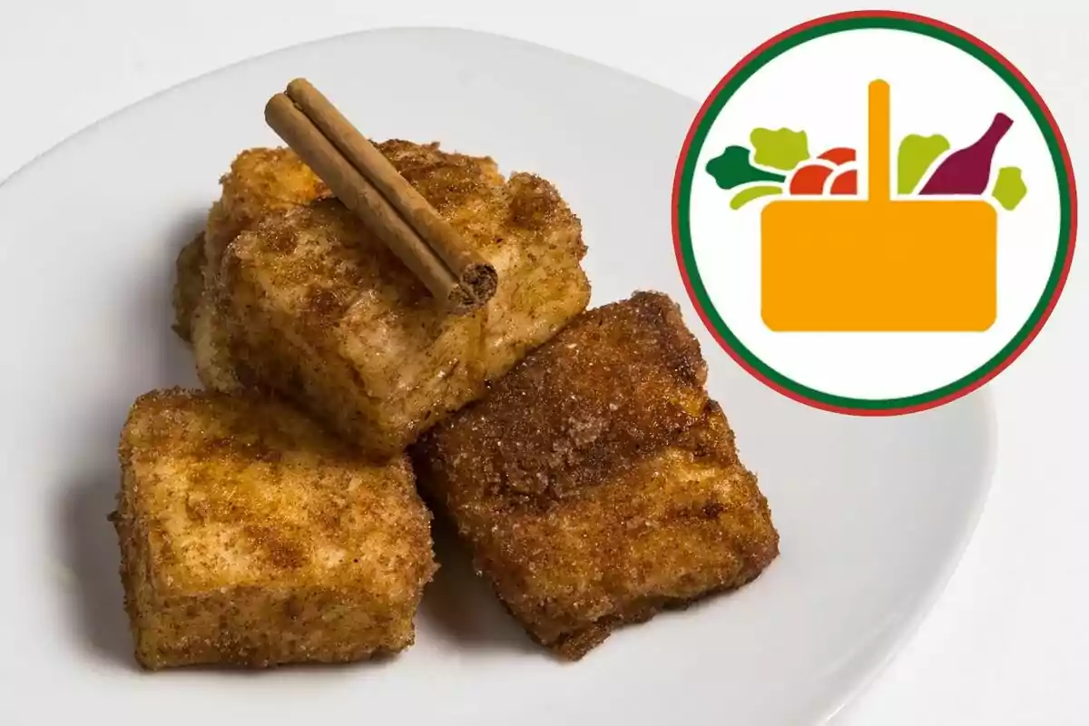 Plato de torrejas espolvoreadas con canela y azúcar, decoradas con un par de ramas de canela, junto a un icono de una canasta de alimentos. Plato de torrejas espolvoreadas con canela y azúcar, decoradas con un par de ramas de canela, junto a un icono de una canasta de alimentos.