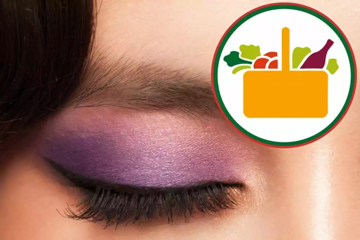 Un ojo cerrado con sombra de ojos morada y un icono de cesta de compras con frutas y verduras en la esquina superior derecha.