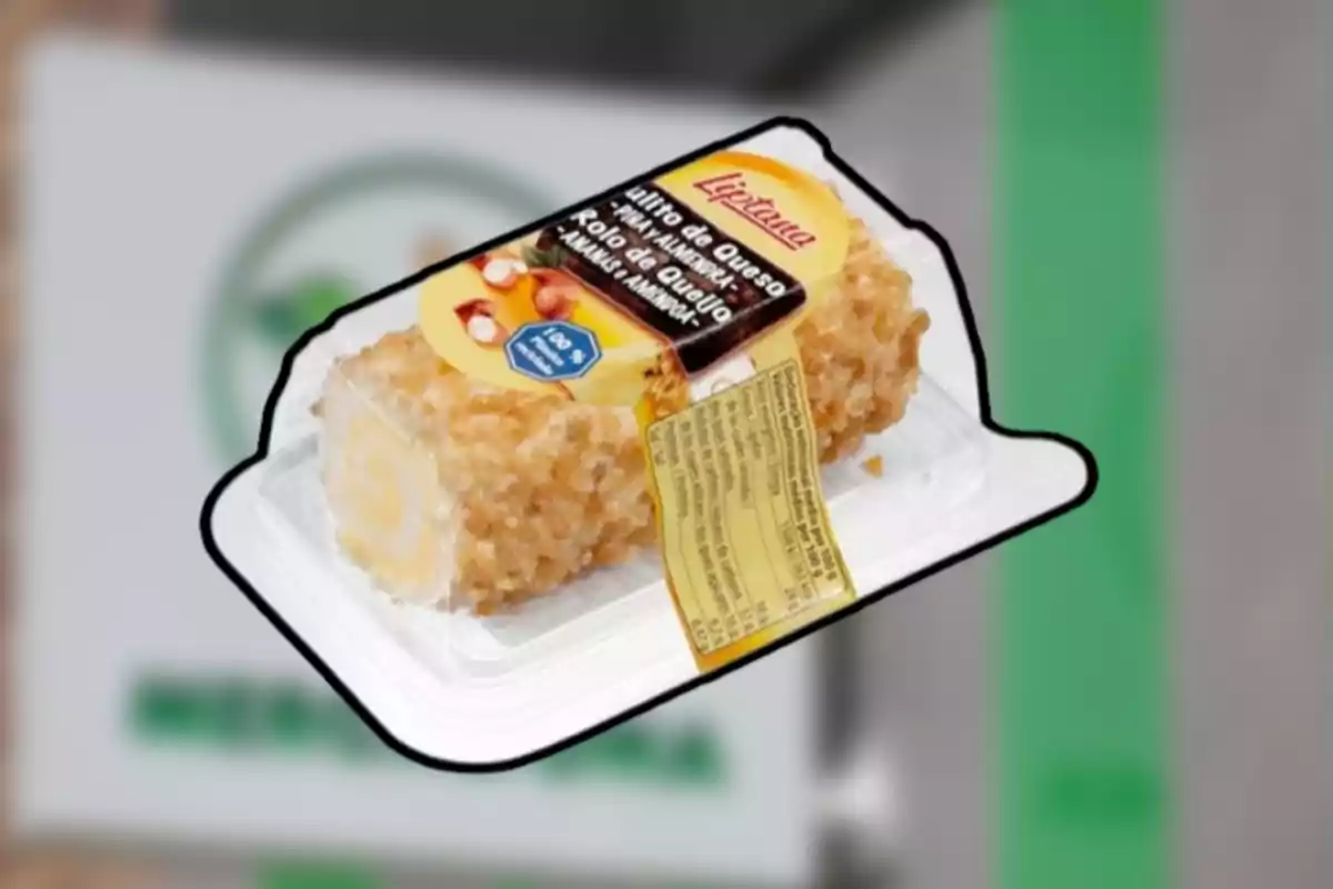 Queso crema en forma de rollo cubierto con trozos de almendra en un envase de plástico transparente Queso crema en forma de rollo cubierto con trozos de almendra en un envase de plástico transparente