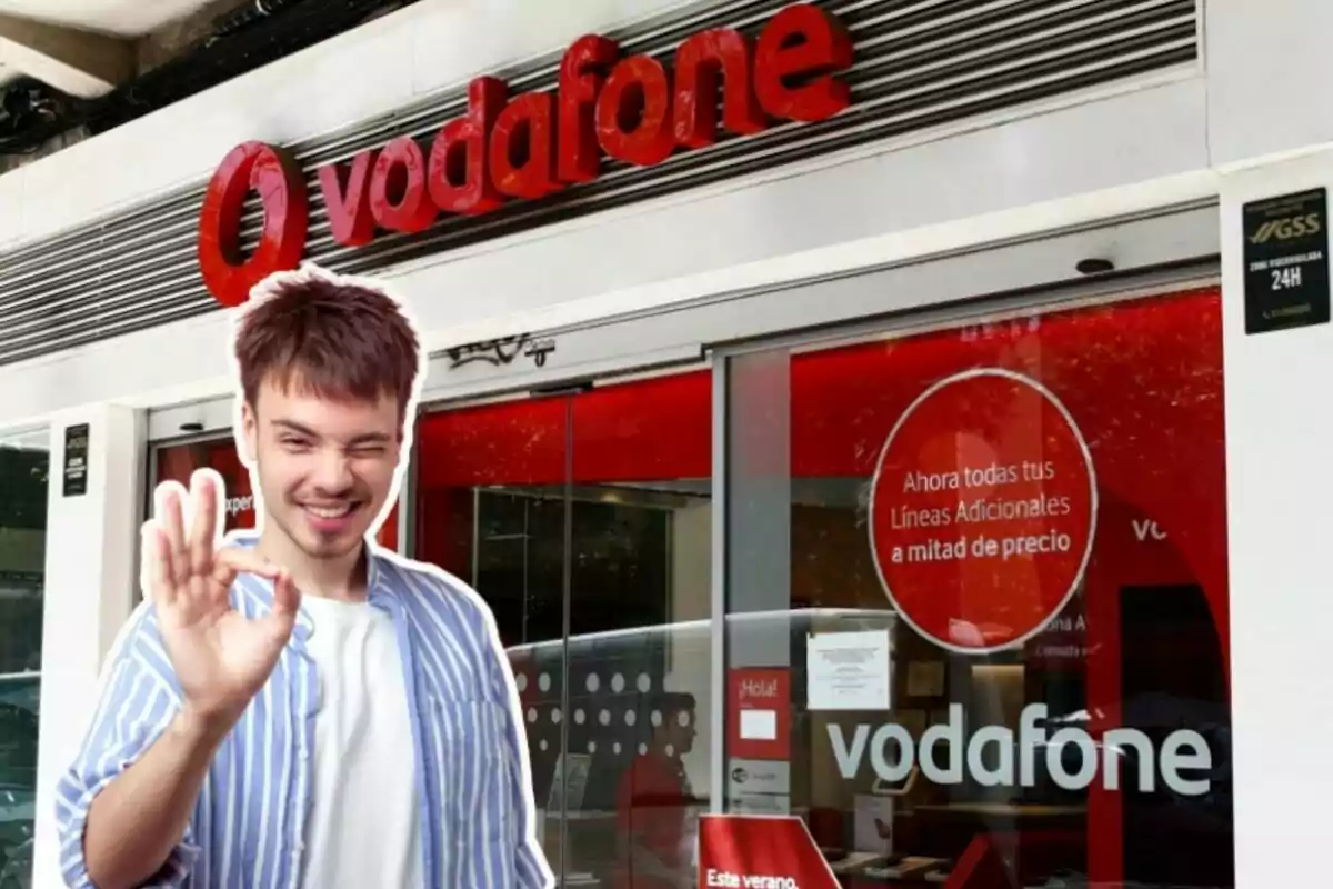 Una tienda de Vodafone, con un chico delante haciendo un gesto de alegría