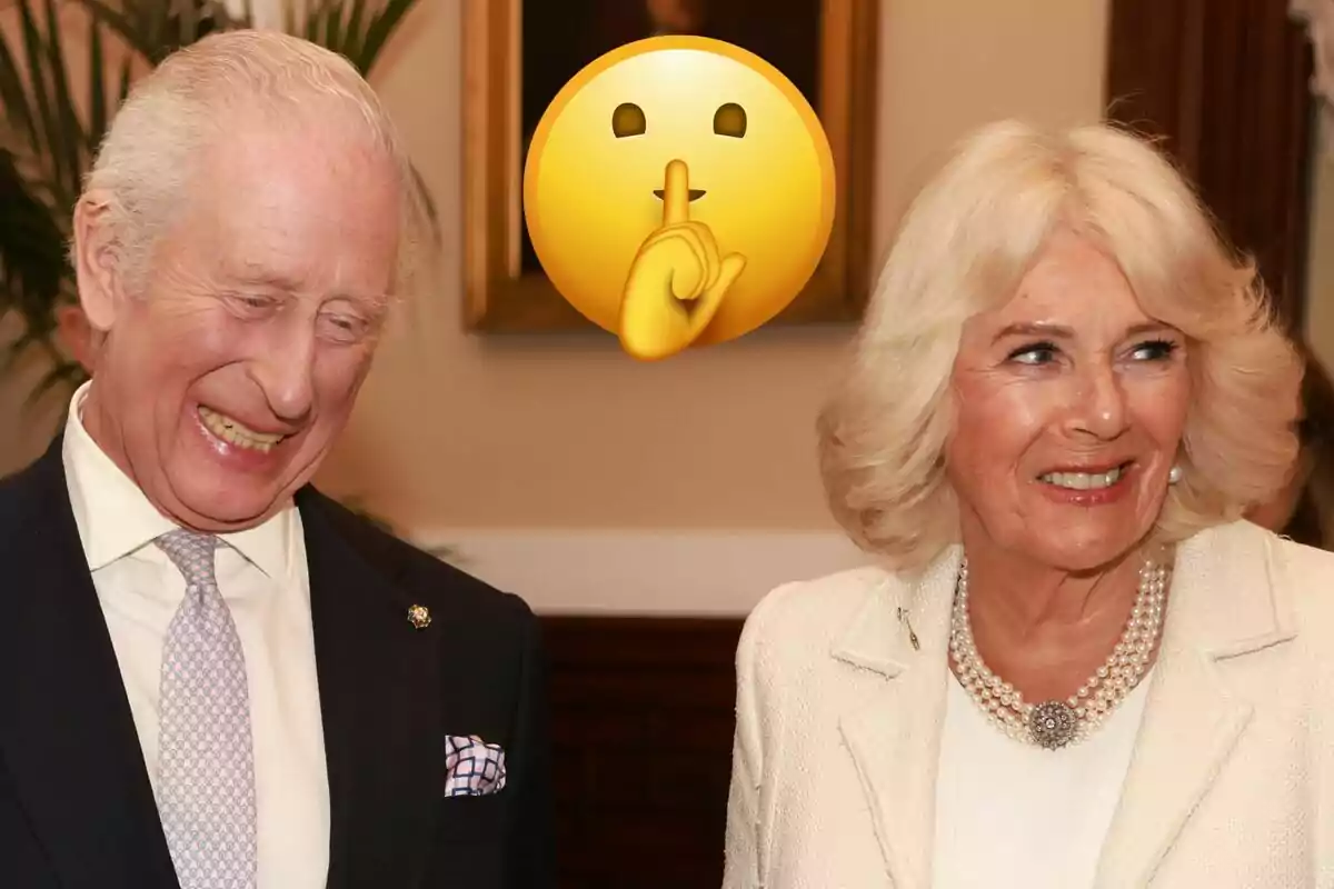 Carlos III laughing in a black suit and Queen Camila in a white jacket with a silence emoji.