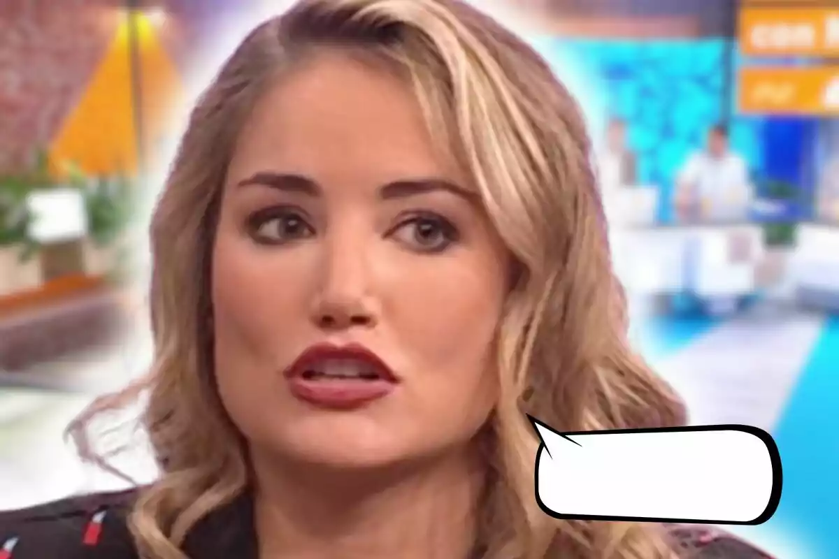 Close-up of Alba Carrillo with a serious expression appears in a television studio setting with an empty speech bubble next to her.