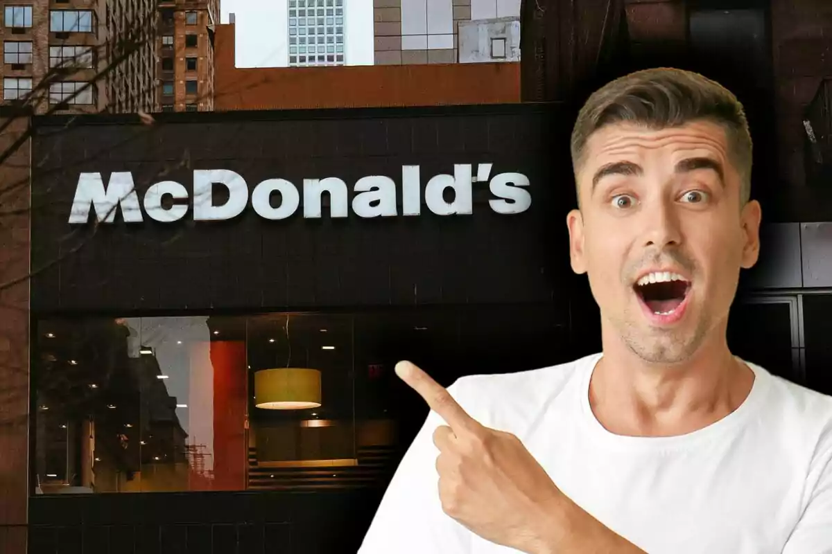 A surprised man points at a McDonald's sign on an urban building.