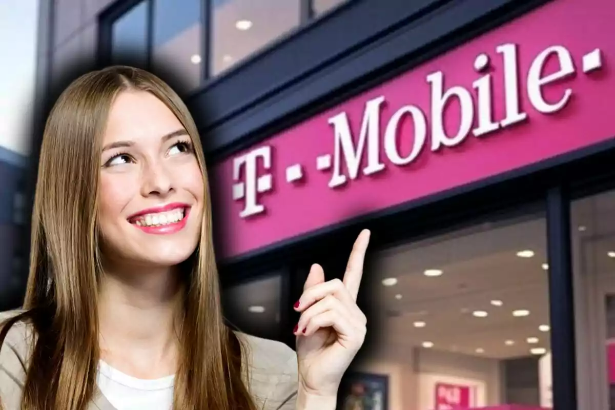 A smiling person points to a T-Mobile sign in a store.