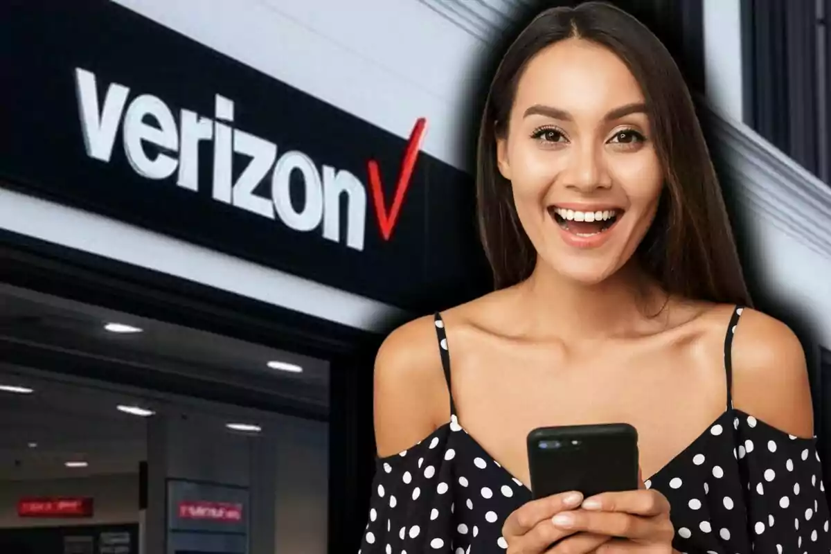 A smiling woman holds a phone in front of a Verizon store in the United States.
