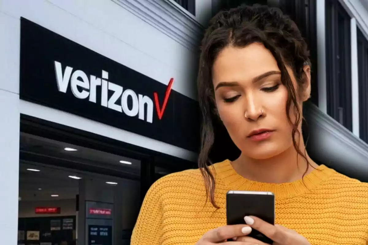 Una persona con suéter amarillo usando un teléfono frente a una tienda de Verizon.