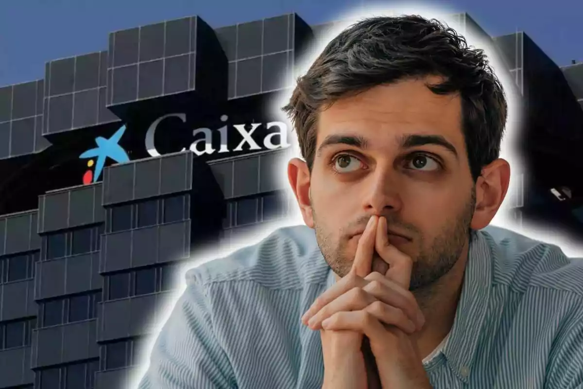 A pensive man with his hands together in front of a CaixaBank building.