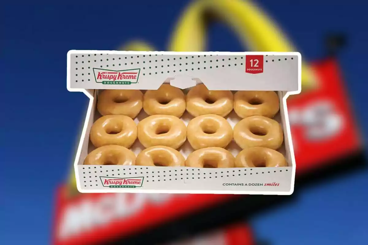 A box of twelve glazed Krispy Kreme donuts in front of a blurred background of a McDonald's sign. A box of twelve glazed Krispy Kreme donuts in front of a blurred background of a McDonald's sign.