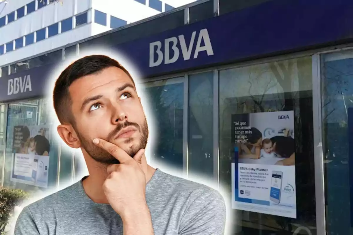 A pensive man in front of a BBVA branch.