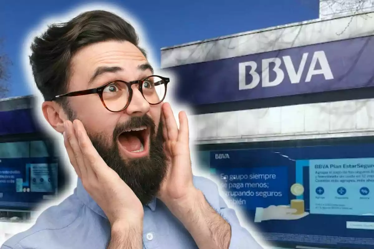 A man with a surprised expression in front of a BBVA building.