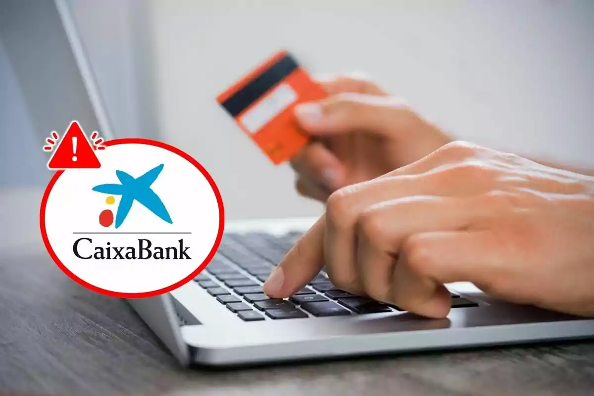 Person using a laptop while holding a credit card with a CaixaBank logo and warning symbol superimposed on it.