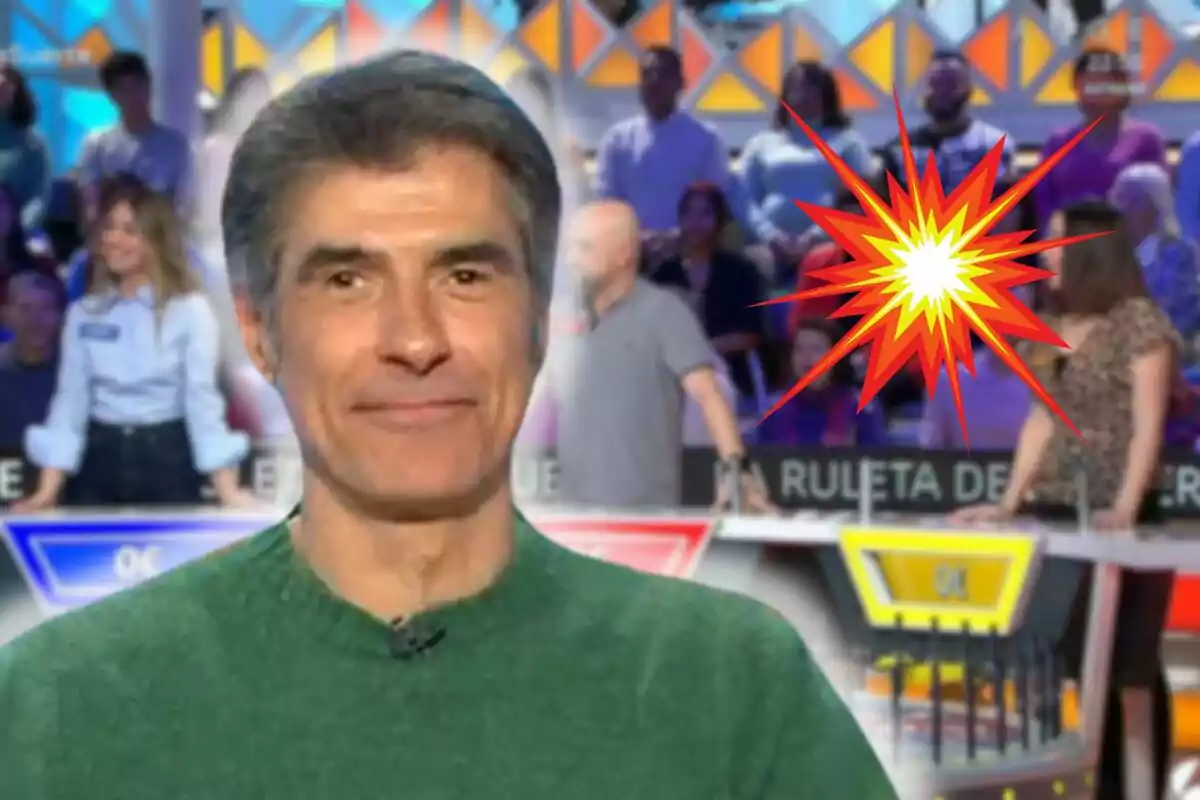 Jorge Fernández in a green sweater smiles in front of a blurred background of a television show with an explosion graphic.